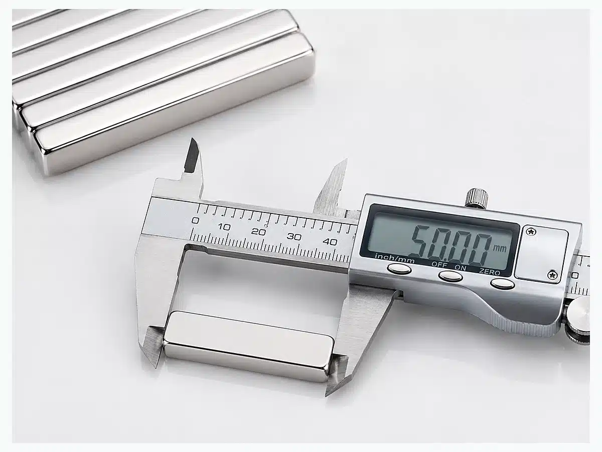 Elongated neodymium bar magnets beside compact rectangular block magnets for geometry comparison